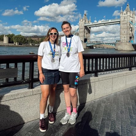 Two of our amazing fundraisers are pictured with their medals and Rape Crisis England & Wales T-shirts after taking aprt in the Ride London challenge event. London's Tower Bridge -- the event finishing point - is in the background.