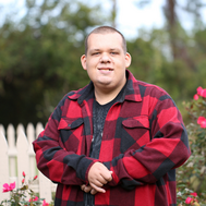 A young man looks at the camera.