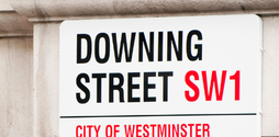 A London street sign reads 'Downing Street', the location of the UK prime minister's official residence.