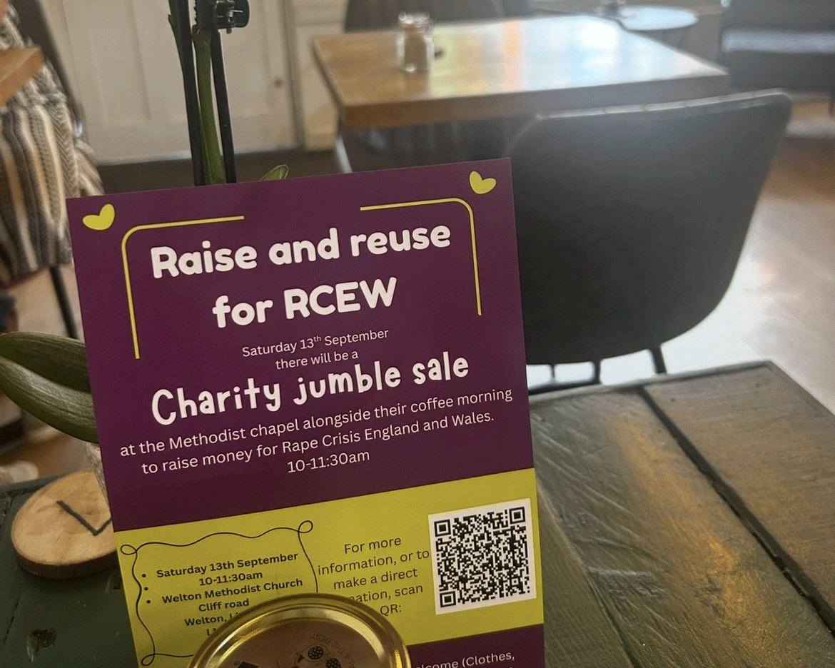 A cafe with a flyer for a charity jumble sale saying "Raise and reuse for RCEW