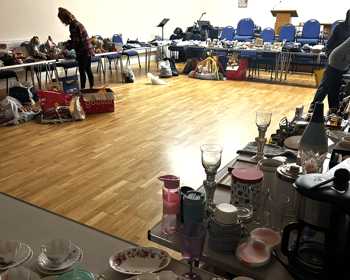 A local church with trestle tables covered in bric-a-brac